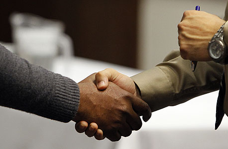 Collegues shaking hands. Photo: Bloomberg