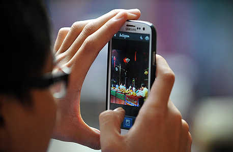 a person using instagram on their phone. Photo: Shutterstock