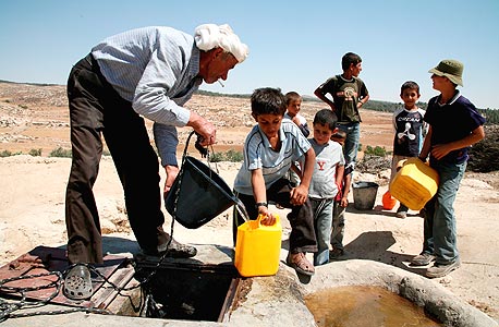 פלסטינים ממלאים מים בכפר יטא פלסטינים ממלאים מים בכפר יטא