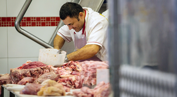 A worker processes meat at a slaughterhouse. Photo: Bloomberg