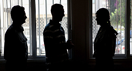 Silhouettes of people conducting business in secret. Photo: Amit Shaal