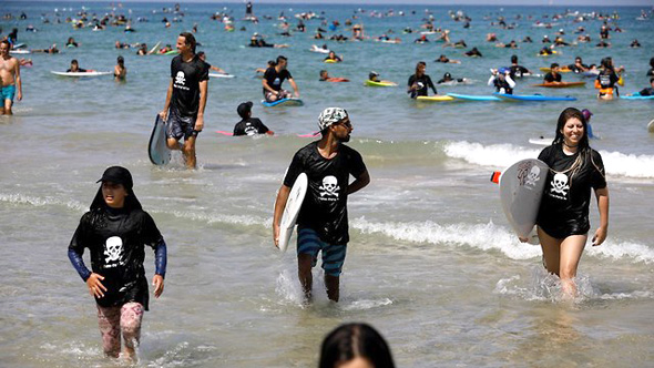 Surfers protesting offshore gas development in Israel. Photo: Reuters