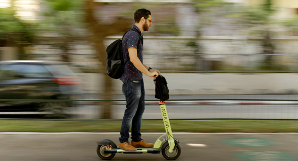 An e-scooter user in Tel Aviv. Photo: Amit Sha