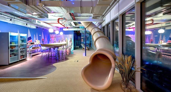 A slide leading to a furnished dining area at Google's Tel Aviv office. Photo: Itay Sikolski A slide leading to a furnished dining area at Google's Tel Aviv office. Photo: Itay Sikolski