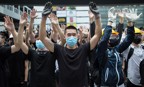 Protesters in Hong Kong covering their face to avoid facial recognition. Photo: EPA Protesters in Hong Kong covering their face to avoid facial recognition. Photo: EPA