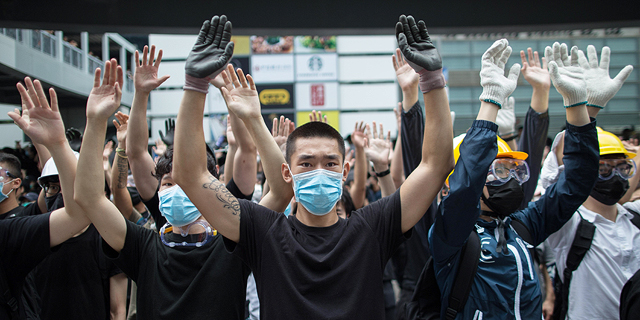 Protesters in Hong Kong covering their face to avoid facial recognition. Photo: EPA 