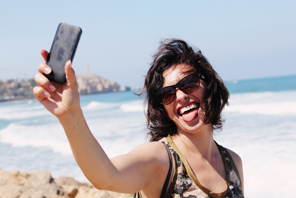 Taking a selfie at one of Tel Aviv's beaches. Photo: Shutterstock Taking a selfie at one of Tel Aviv's beaches. Photo: Shutterstock