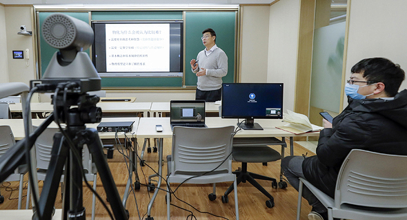 A professor at Peking University teaching a remote class. Photo: TNS