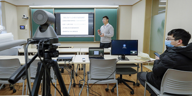 A professor at Peking University teaching a remote class. Photo: TNS