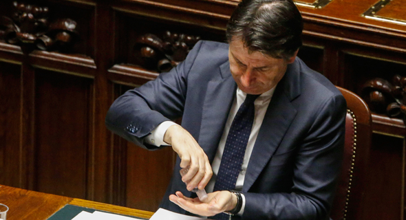 ראש ממשלת איטליה ג'וזפה קונטה מחטא ידיו אחרי נאום בפרלמנט