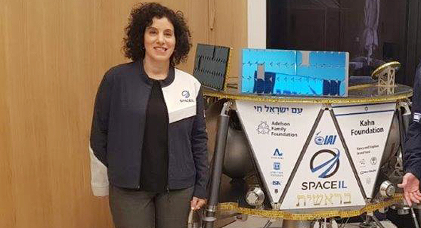 Inbal Kreiss stands next to Israel&#39;s first lunar spacecraft, Beresheet. Photo: IAI