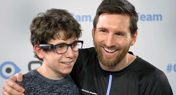Lionel Messi gifts a boy the OrCam MyEye. Photo: OrCam Lionel Messi gifts a boy the OrCam MyEye. Photo: OrCam