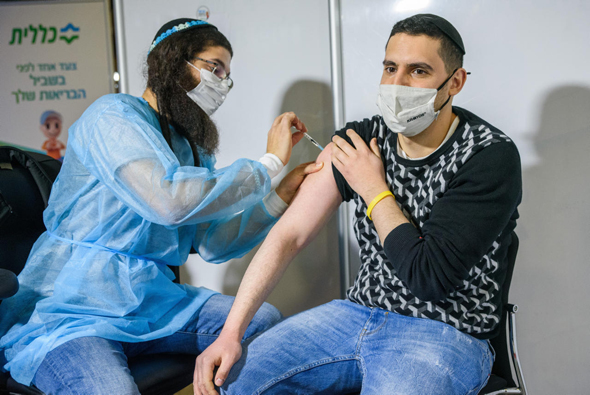  A young man receiving the Covid-19 vaccine. Photo: Shalev Shalom