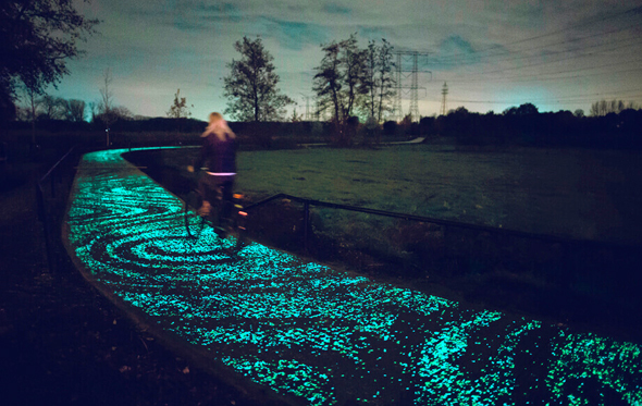 A woman walks on a path highlighted by bacteria emitting phosphorescence in the Netherlands. Photo: Pim Hendricksen