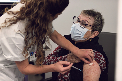 קשישה מקבלת חיסון נגד קורונה בביה"ח איכילוב, צילום: אביגיל עוזי