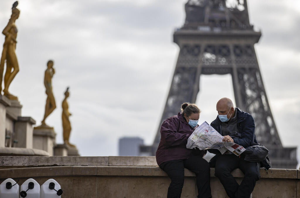 קורונה תיירים עם מסכות למרגלות מגדל אייפל ב פריז