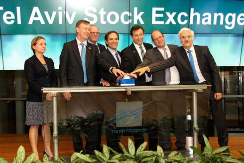 Friedman and others ring the bell at the Tel Aviv Stock Exchange. 