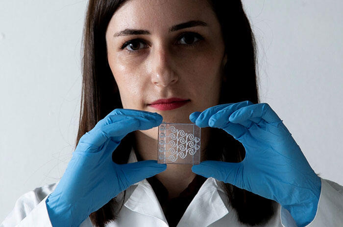 Eliana Steinberg holds a piece of the chip she developed 